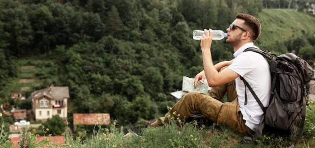 Man traveling alone drinking water