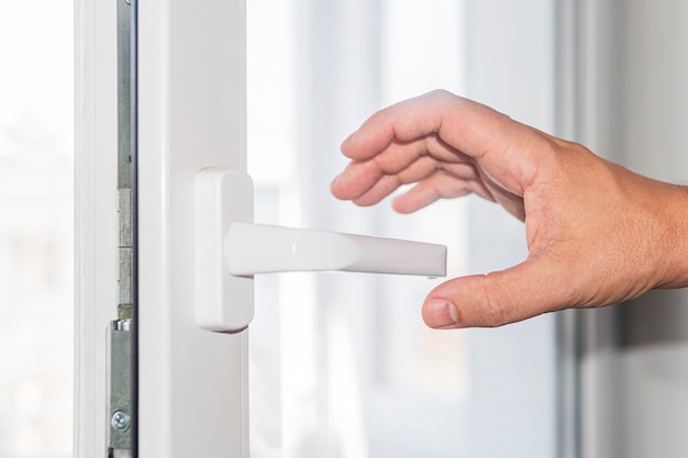 The man tries to open the door with his hand on the door handle. Risk of Contracting a skin disease or virus.