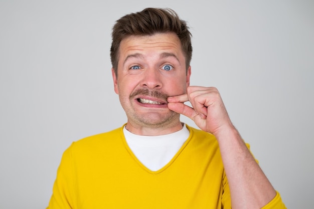 Man trying to keep secret mouth and lips shut as zip with fingers