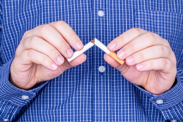 Man trying to quit smoking. Conceptual image. No smoking message.