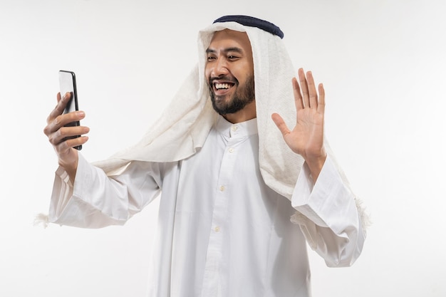 Man in a turban using a mobile phone video conference and calling