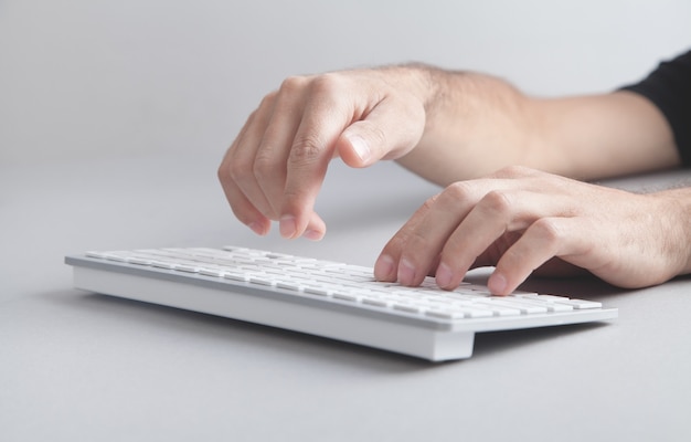 Man typing on computer keyboard.