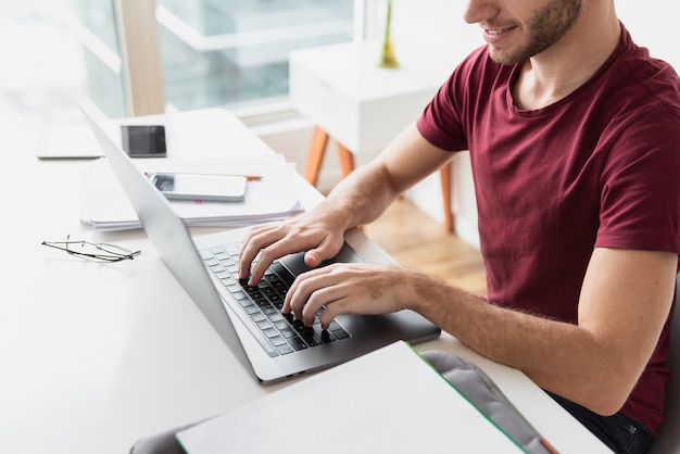 Man typing on his keyboard high view