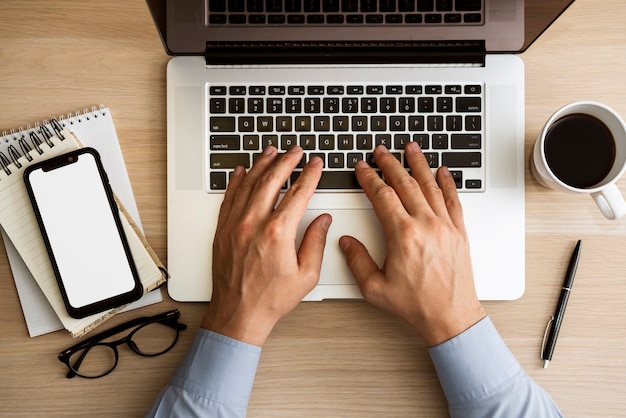 Man typing on laptop top view