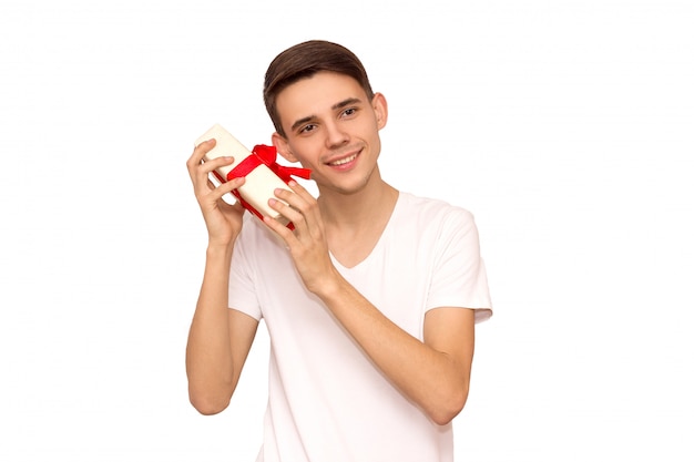 Man unleashes a ribbon bow. Surprise concept. Isolated front view on white background, happy guy