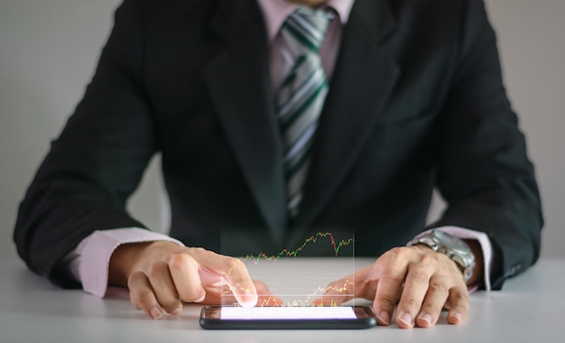 A man use checking a business graph with a hand touch screen smartphone technology