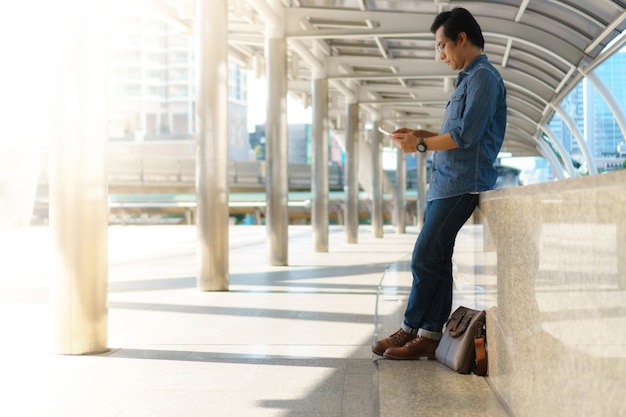 Man use of tablet computer in the city 