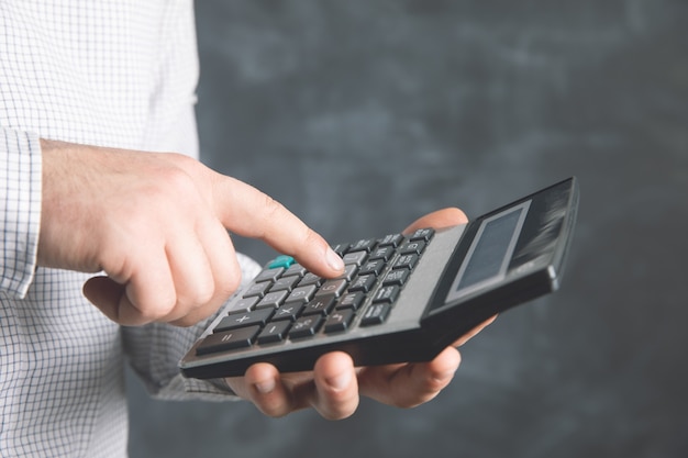 A man uses a calculator .