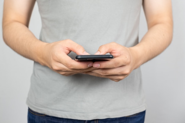 Man uses his Mobile Phone , close up