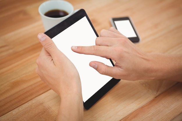 Man using digital tablet at desk in office