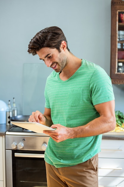 Man using digital tablet in kitchen