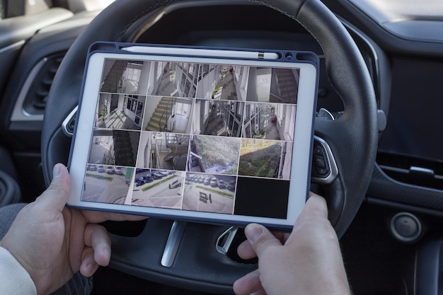 Man using digital tablet for monitoring CCTV cameras of office locations Security equipment