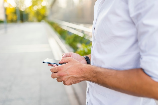 Man using his Mobile Phone in the street