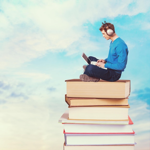 Man using laptop on the books