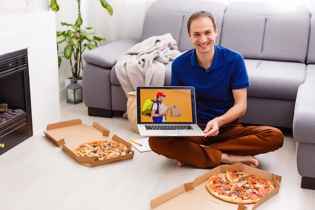 Photo man using laptop for online food order during quarantine, closeup. delivery service