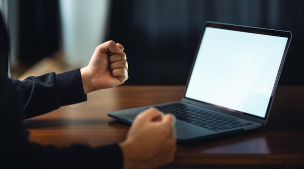 Man using laptop with white blank screen mockup