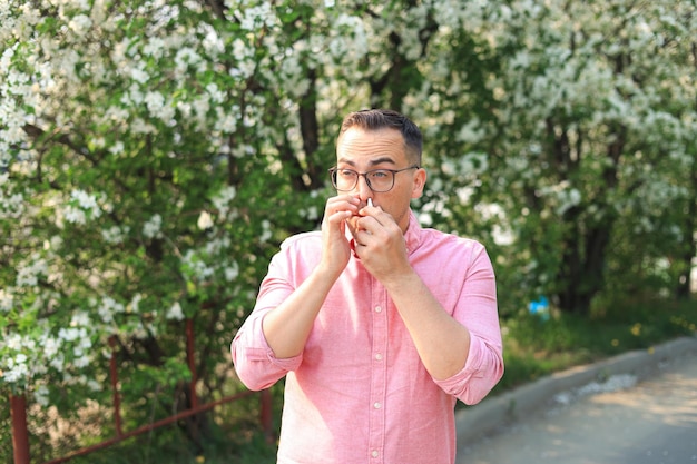 Man using nasal spray during seasonal allergies