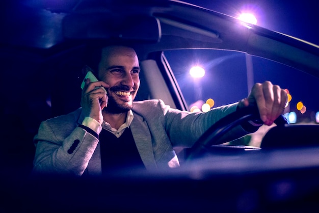 Man using smart phone in his car