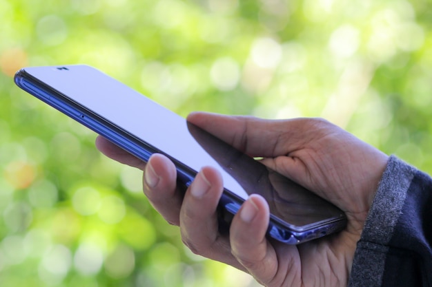 A man using smartphone for connect to social network.