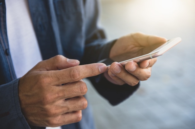 Man using smartphone technology Businessman holding mobile phone