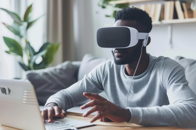 Man using VR headset at home working on a laptop and interacting with virtual elements showcasing