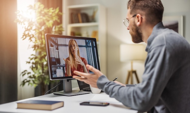 Man on videocall with colleague