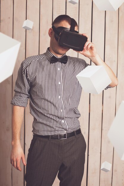 Photo man in virtual reality helmet for smartphone. vr glasses.