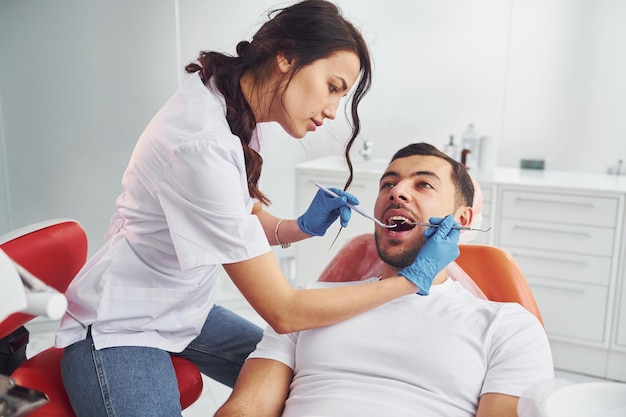 Man visiting dentist in clinic Conception of stomatology