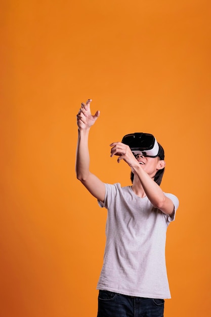 Man in vr headset playing virtual reality games in metaverse. Person in ar goggles enjoying augmented simulation experience, cyberspace entertainment, modern lifestyle and pastime