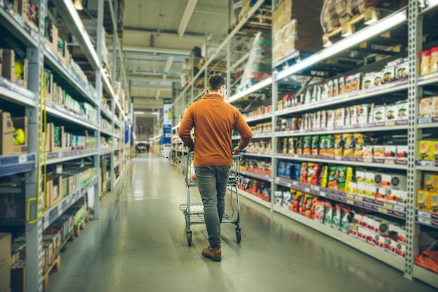 Man walk between rows of store. shopping concept