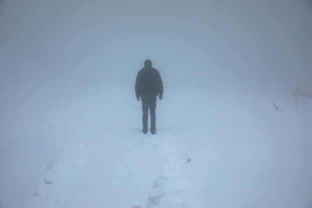 Man walking alone on snow field