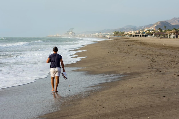 Man walking along the seashore