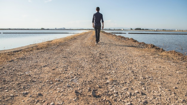 Man walking back to back on a path