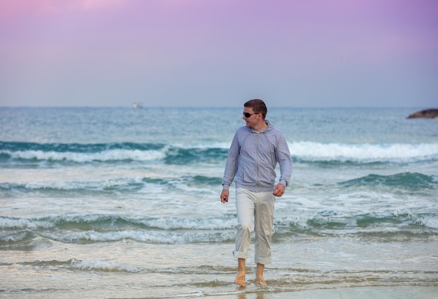 Man walking on the beach Person going on seaside