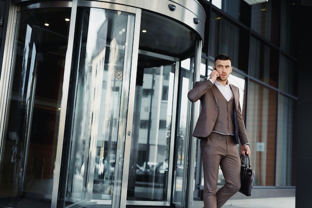 Man walking out of a business office. businessman walking out of modern office center.