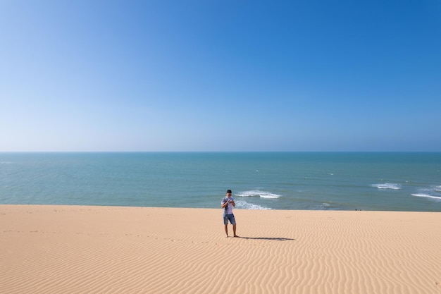 Man walking in sand dunes in the desert La Macuira La Guajira Colombia