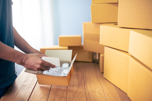 Man in warehouse working with packages online shopping concept