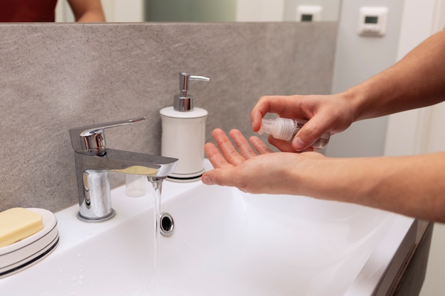 A man washes his hands thoroughly because of an epidemic.