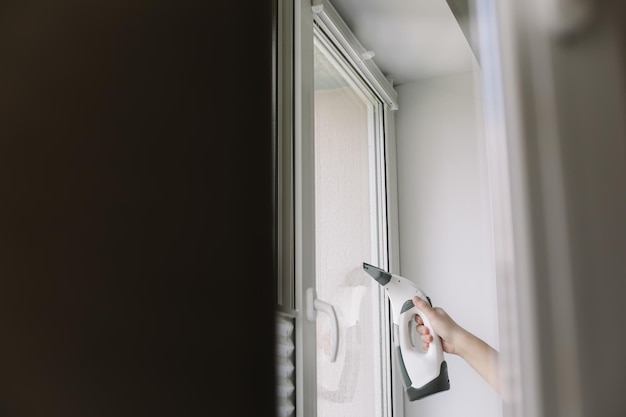 Man washing and cleaning window at home Housework and housekeeping home hygiene