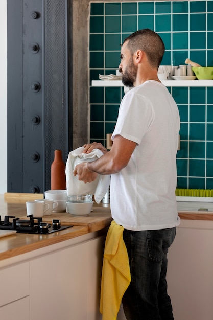 Man washing dishes medium shot