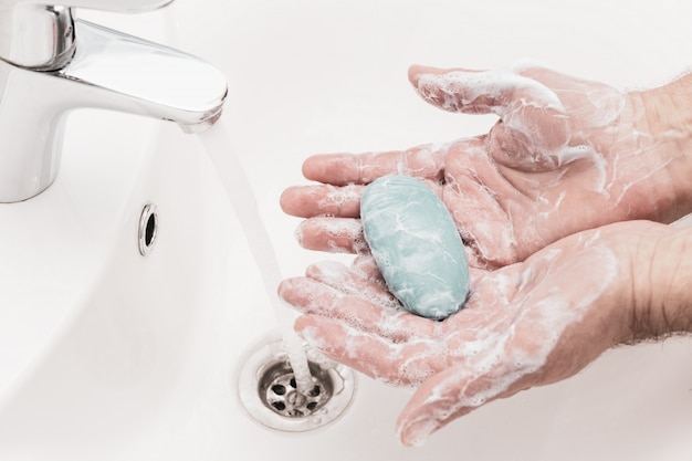 Man washing hands with antibacterial soap for corona virus prevention, hygiene to stop spreading coronavirus.