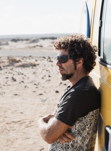 Man watching the landscape outside the camper van