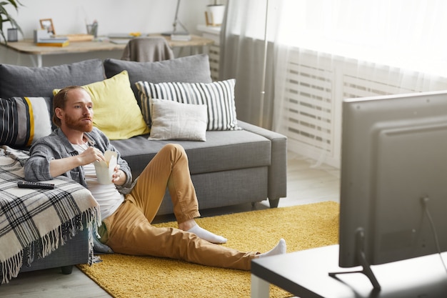 Man Watching TV in Bachelor Pad