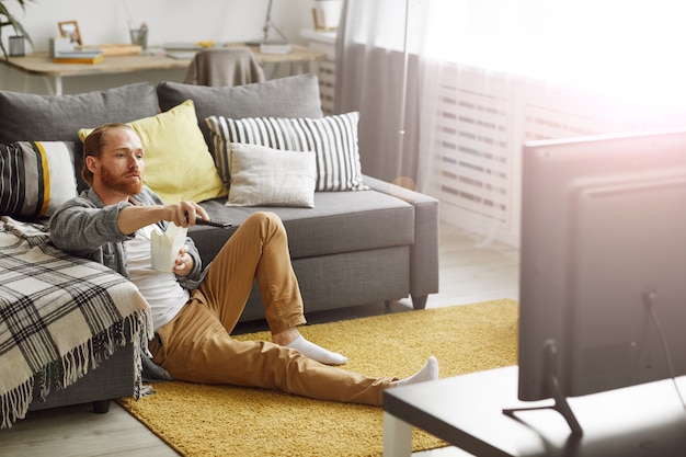 Man Watching TV on Floor