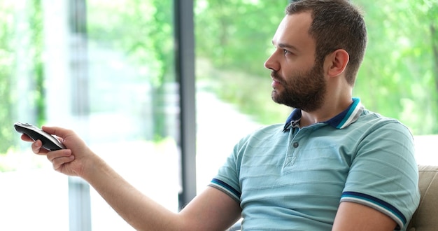 man watching tv at modern villa