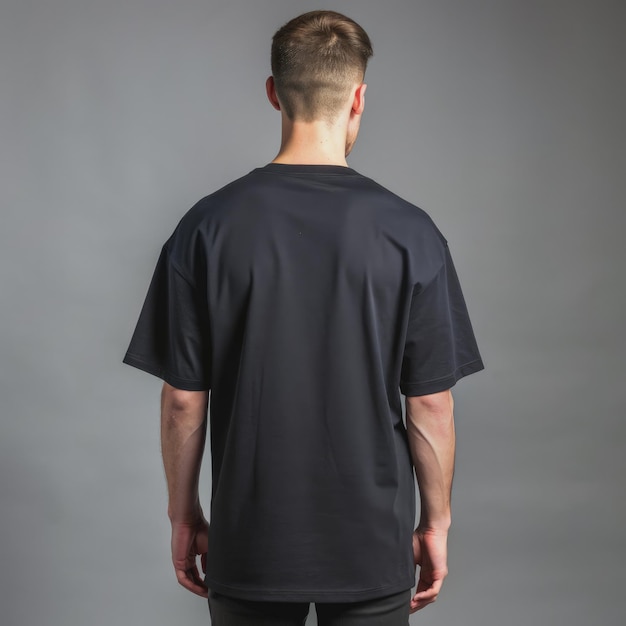 Photo man wearing a black oversized tshirt standing in front of a gray background generative ai