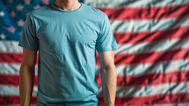 A man wearing a blank blue Tshirt in front of a blurred American flag