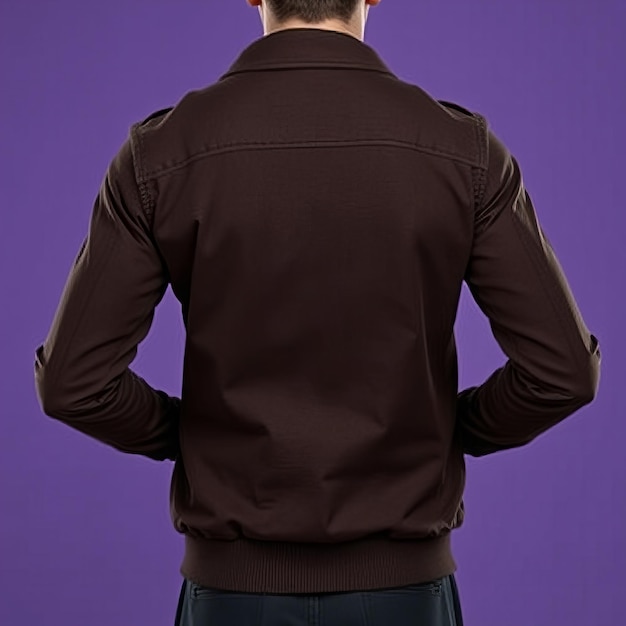 a man wearing a brown shirt with the words  the back  on the back of his shirt