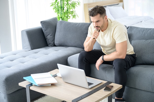 A Man wearing casual cloth working from home, online meeting, video call, conference and studying online with stressful