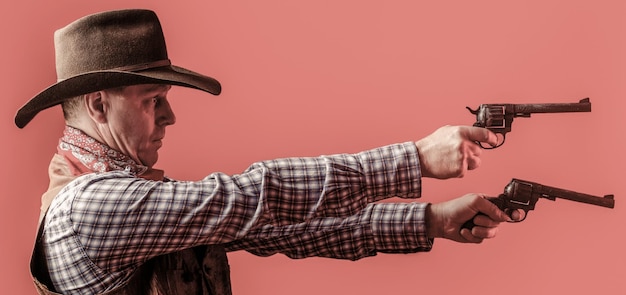 Man wearing cowboy hat gun Portrait of a cowboy West guns Portrait of a cowboy Western man with hat Portrait of farmer or cowboy in hat American farmer